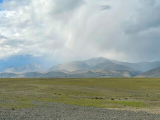 Rain cloud and rain coming from it in the Altai mountains