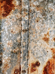 background of very old metal aluminum garage wall or fence with corrosion and rust