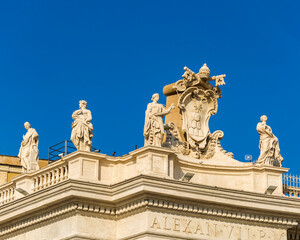 Fototapeta na wymiar Saint statues and coat of arms of the Vatican, Rome, Italy