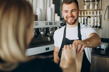 Fototapeta premium Barista packing take away snacks at a coffee shop