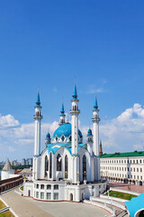 Fototapeta na wymiar Kul Sharif Mosque in Kazan Kremlin, Tatarstan, Russia - July 2021. A majestic mosque made of white stone with a blue roof, surrounded by a red brick wall