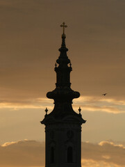The church tower with cross in the morning, with flying bird and  sky background