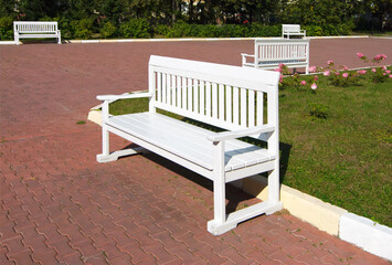 White, wooden park benches