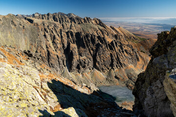 Obraz premium Peaks and frozen tarn in High Tatras mountains, Slovakia. View from peak Krivan