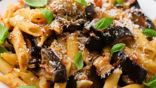 Pasta alla Norma with eggplant or aubergine, tomato, parmesan and basil. Rotating video