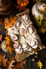Pumpkin cinnamon rolls with buttery icingn with autumn decoration