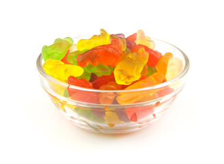 Many gummy candies in bowl isolated on white background