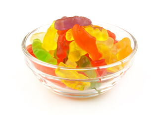 Colorful gummy candies in glass bowl isolated on white background