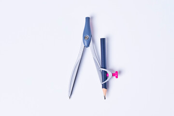 Drawing Compass with pencil on white background. A school compass with a blue pencil on white backdrop