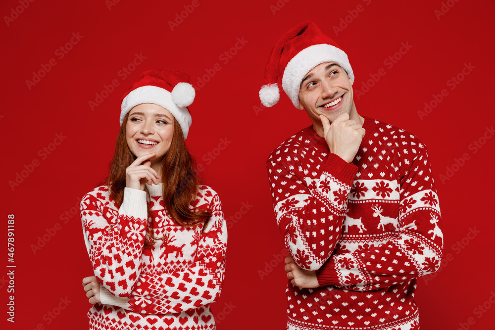 Wall mural young pensive couple friends two man woman 20s in sweater hat look aside prop up chin isolated on pl