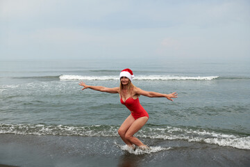 beautiful girl in a red swimsuit on the sea beach