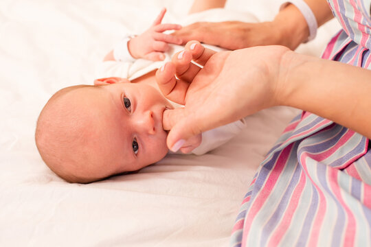 Mom prepare her newborn baby to breastfeed