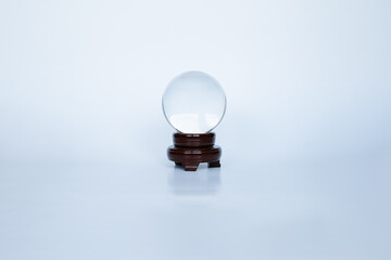 crystal ball with dark wood podium on white background. Divination and fortune teller