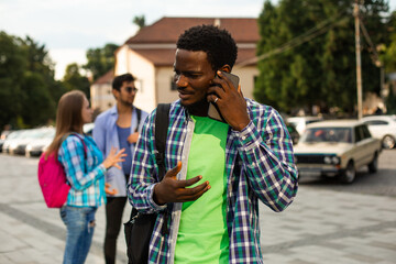 The young african student uses navigation on a smartphone