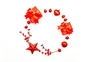 White Christmas and New Year background with red Christmas balls, big star and berries, gift boxes. Top view, copy space