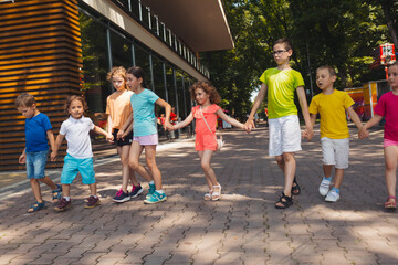 The group of excited preschoolers are running together