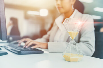 Business Woman Working race against time with Times Hourglass on Desk Clock for Office Working...