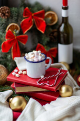 Obraz na płótnie Canvas winter holidays, christmas and celebration concept - close up of camp mug with whipped cream and marshmallow, candy canes, books and decorations on window sill at home