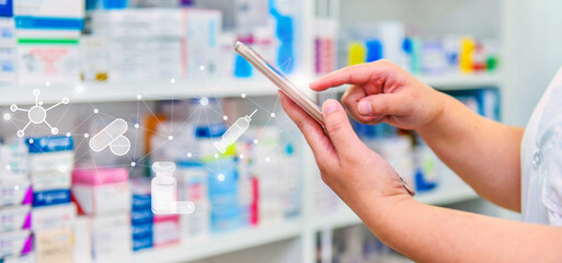 Pharmacist using mobile smart phone for search bar on display in pharmacy drugstore shelves...