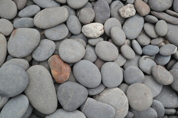 organic shapes of grat rocks on the beach design for material textured background