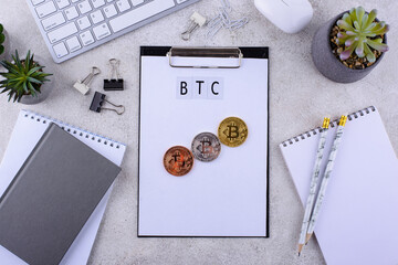 Bitcoin coins on office desk. Cryptocurrency concept