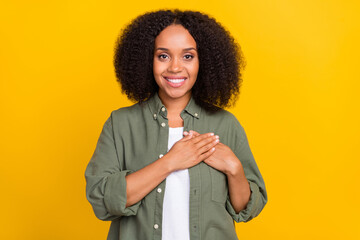 Photo of cute brunette millennial lady hands breast wear khaki shirt isolated on yellow color background