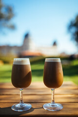 Ice coffee in two glasses in a park, for chilling and refreshment on a perfect sunny day