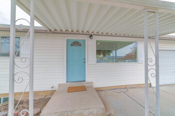 Entrance of a home with wrought iron porch railings