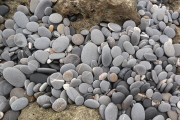 organic shapes of grat rocks on the beach design for material textured background