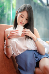 Portrait of young Asian beautiful cute girl in cafe, lifestyle concept