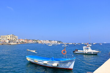 Fototapeta na wymiar boats in front of the coast and beach in Ischia, Italy