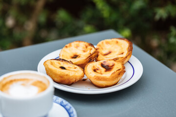 Egg custard tarts called Pasteis de Nata with two coffees 