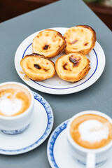 Egg custard tarts called Pasteis de Nata with two coffees 