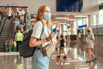 Blonde hair female tourist with baggage near international airport. Woman ready to board the...