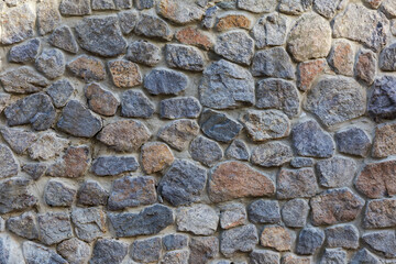 Retaining wall faced with natural rough stones different sizes