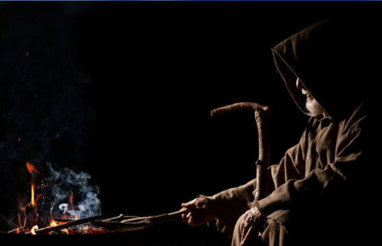 Old druid and celt sit by the fire