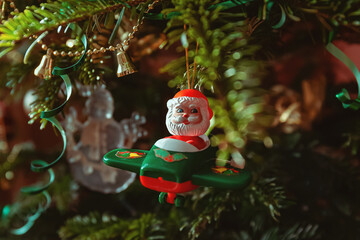 Toy of Santa on a plane on a christmas tree