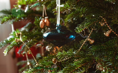 Blue glass toy on a christmas tree