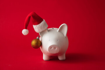 Festive financial savings concept. Piggy bank with Christmas decorations