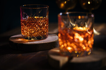 Two glasses of cocktail called Aperol Spritz in a fancy glasses in dark moody atmosphere