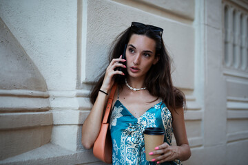 Beautiful young elegance woman using the phone. Beautiful fashion woman talking to the phone..