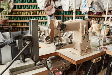 Image of sewing machine and other equipment for shoemaker for work in the factory