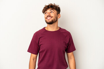 Young mixed race man isolated on grey background relaxed and happy laughing, neck stretched showing teeth.