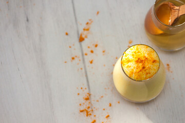 Glass with turmeric powder with honey. Healthy ayurvedic drink, detox beverage. Copy spase.