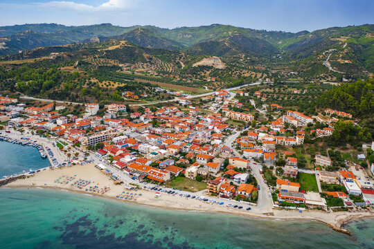 Typical greek village, beach, orange roofs, mountain. Nea Skioni, Halkidiki, Greece
