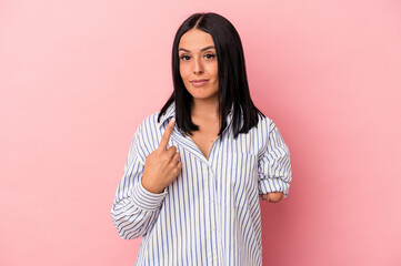 Young caucasian woman with one arm isolated on pink background pointing with finger at you as if inviting come closer.