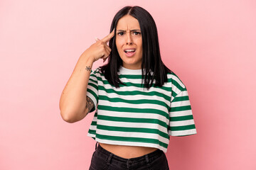 Young caucasian woman with one arm isolated on pink background showing a disappointment gesture with forefinger.