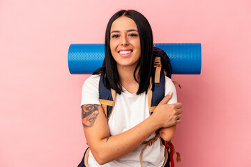 Young caucasian hiker woman with one arm isolated on pink background laughing and having fun.