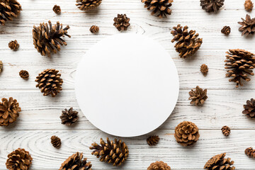Creative frame made of Christmas pine cones with square Paper blank. Xmas and New Year theme. Flat lay, top view copy space