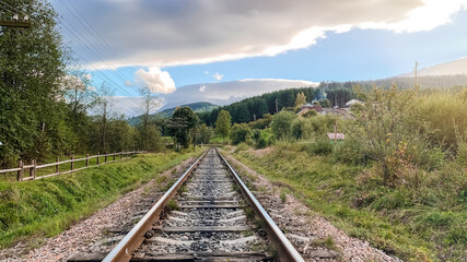 Fototapeta na wymiar Railroad tracks on the background of the village landscape